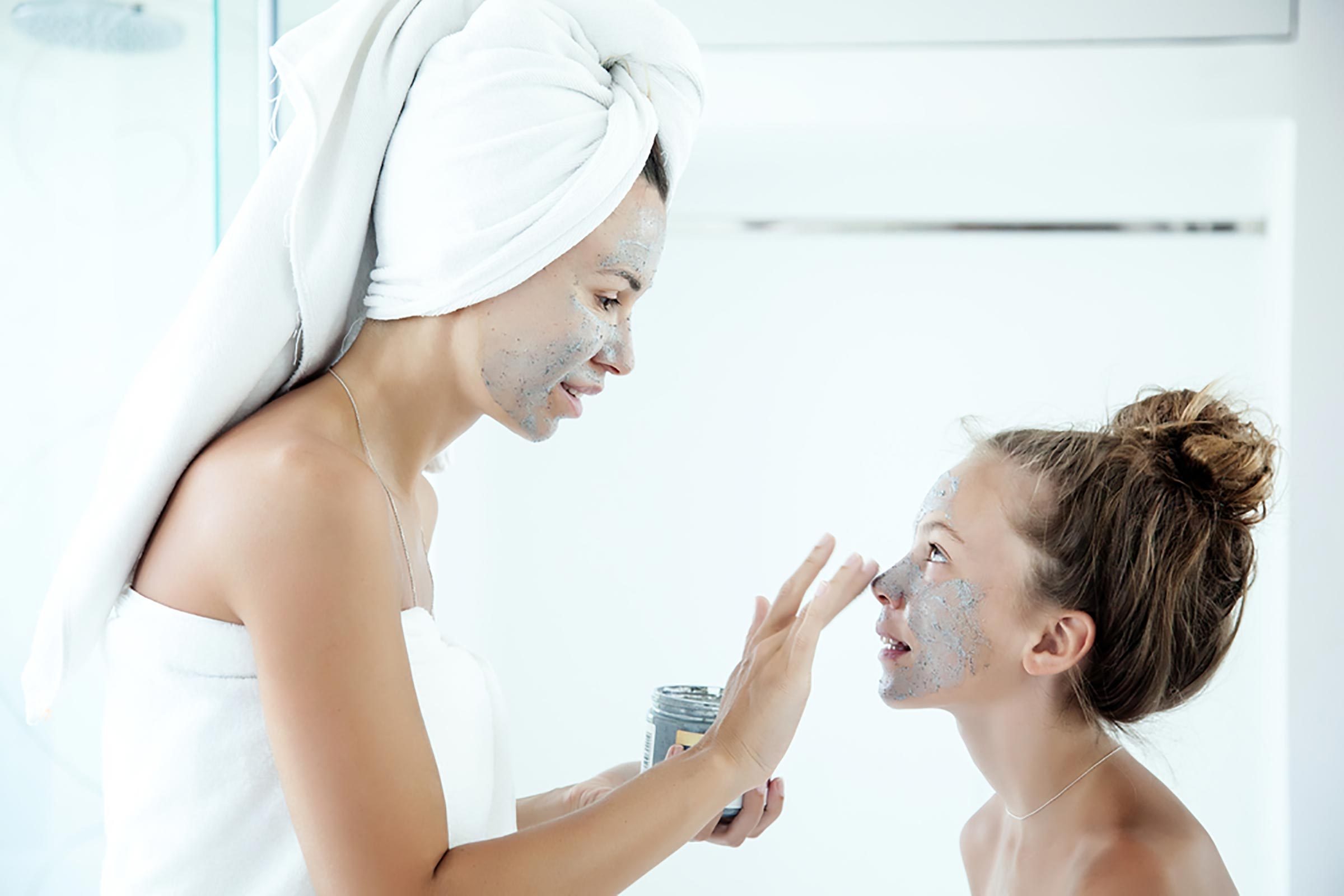 two women with green clay masks