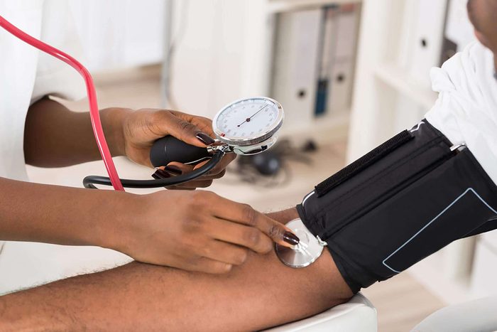 doctor checking blood pressure