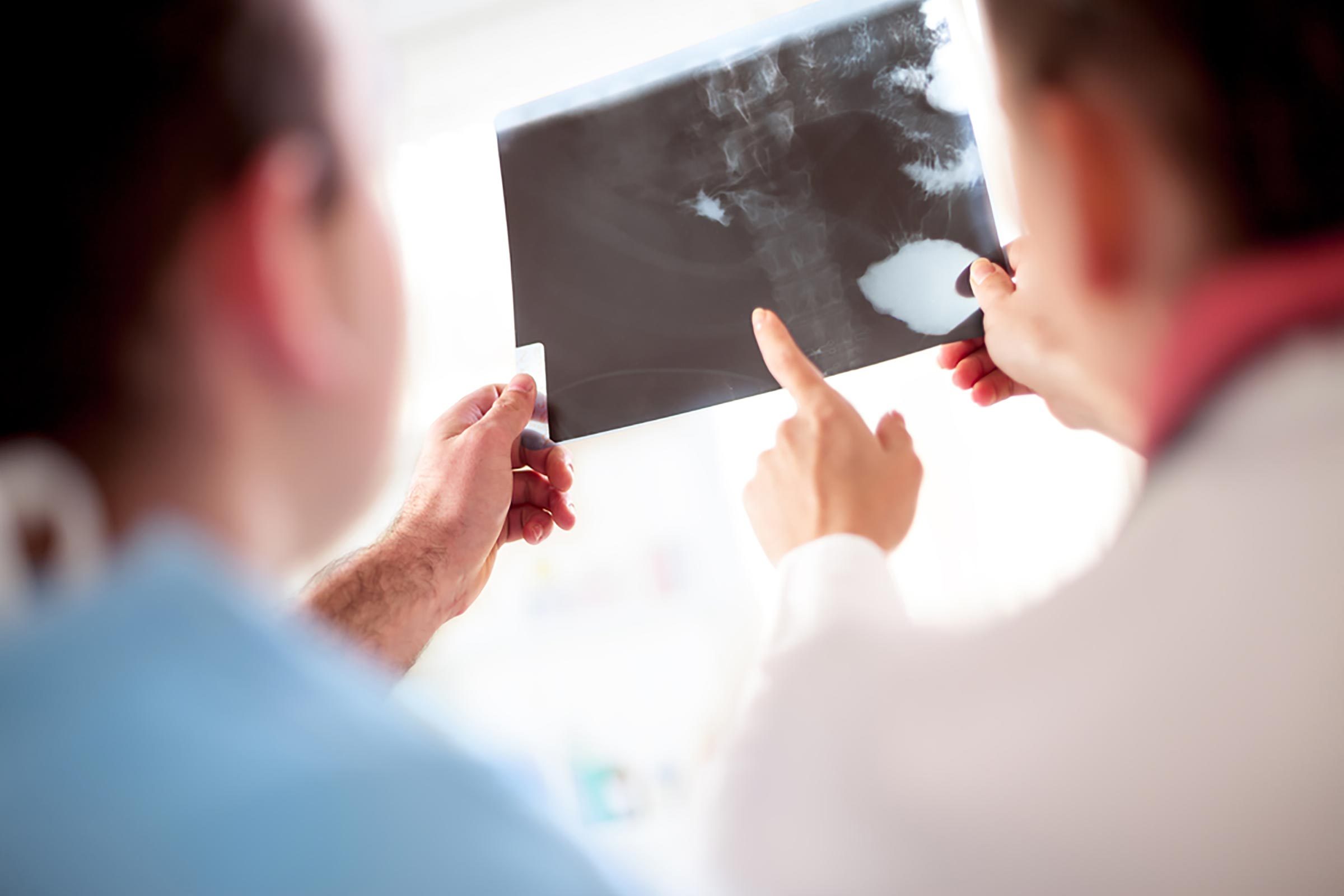 a doctor and a patient looking at an x-ray