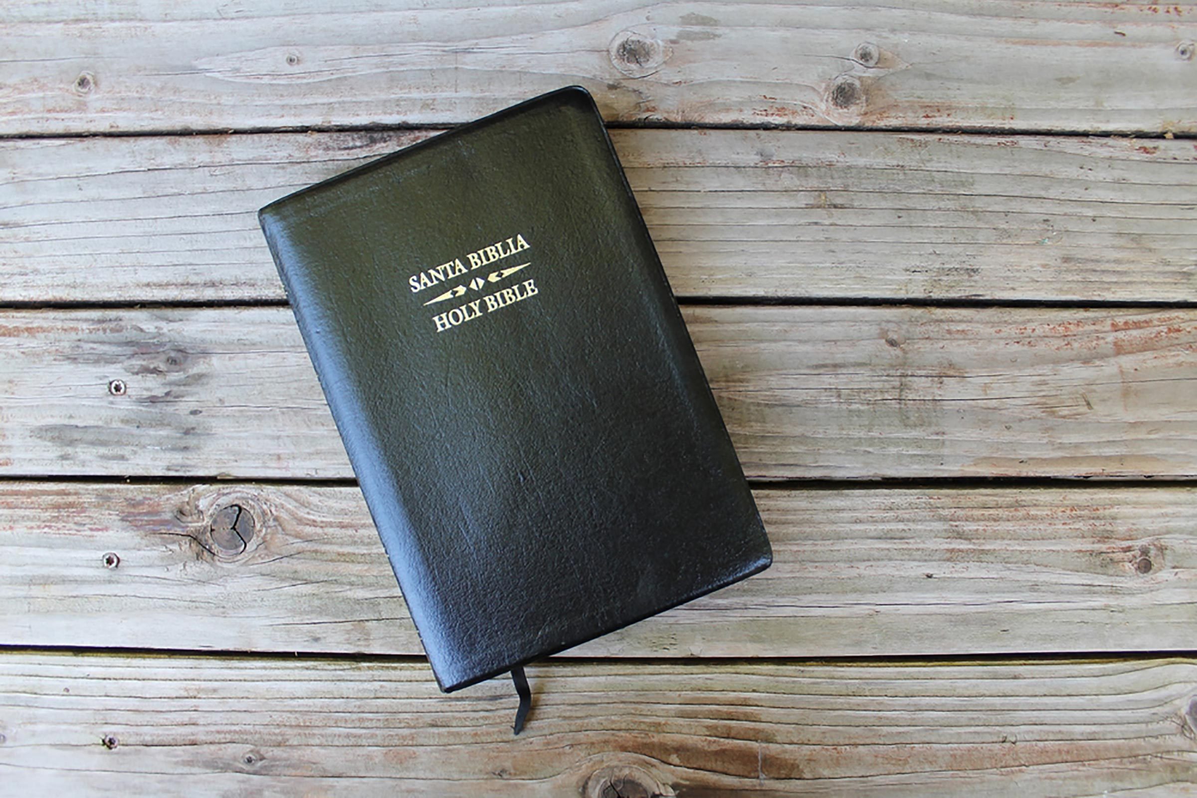 a leather-bound bible on a wooden table