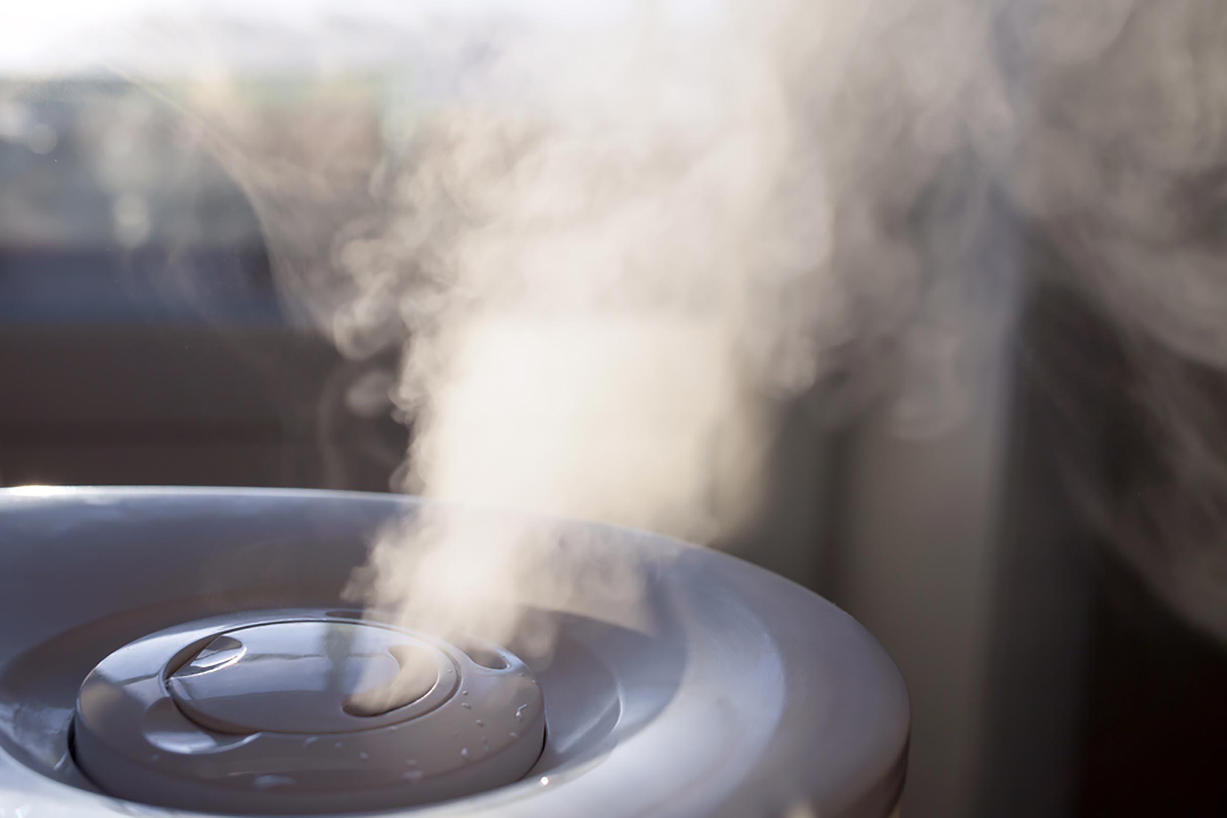 Humidifier emitting steam in dark room