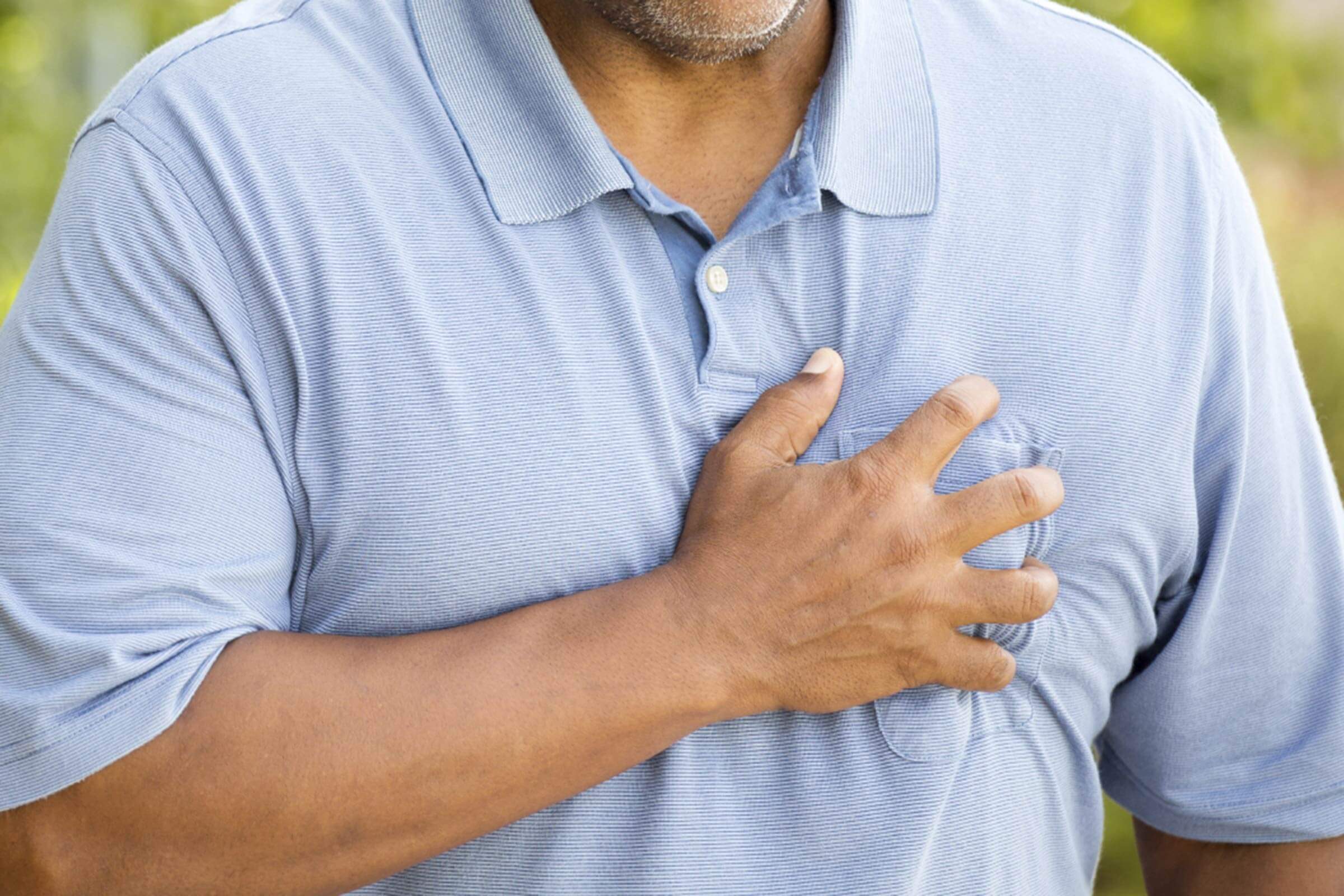 Large man gripping his crest.