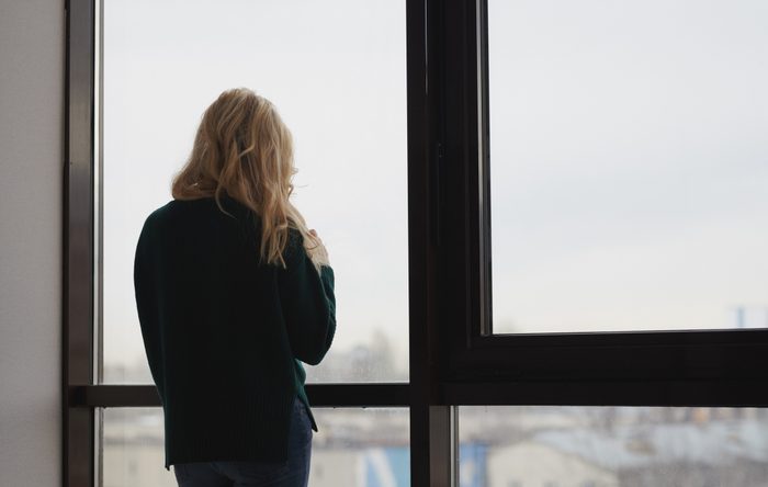 rear view of woman looking out window