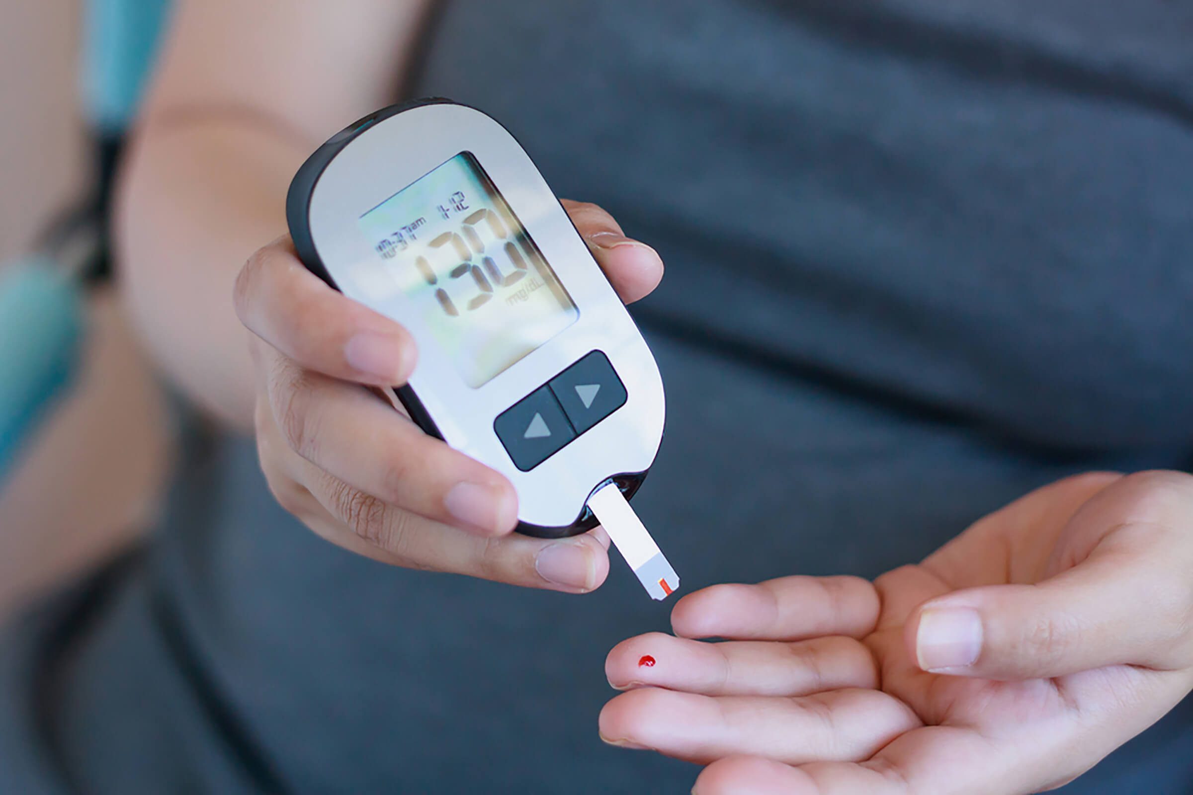 woman testing blood glucose level