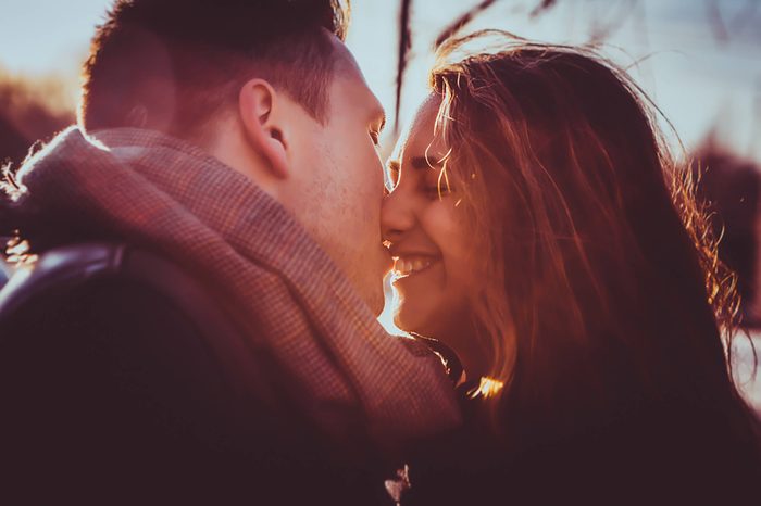 a couple kissing in winter outdoors