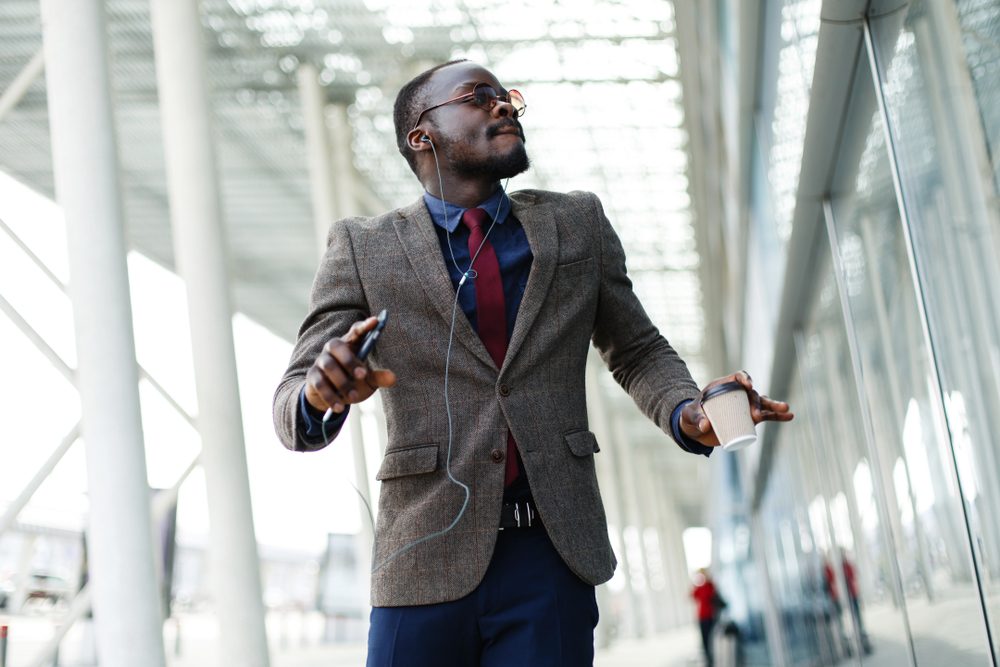 happy man listening to music on headphones