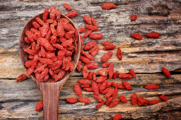 goji berries wood table and spoon