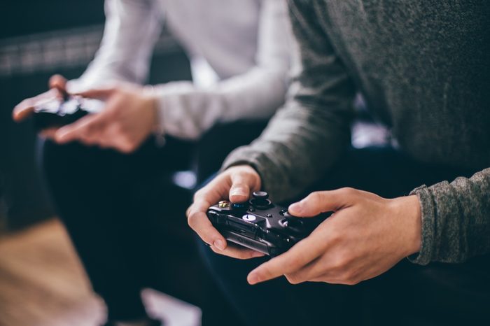 CHELYABINSK, RUSSIA, FEBRUARY 23, 2017: two young people holding a black game controller for the Microsoft Xbox, a video game console.