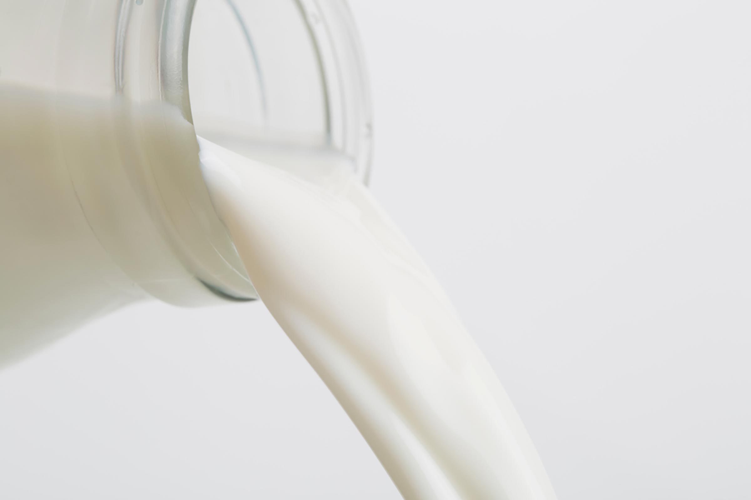 Milk pouring out of a glass bottle