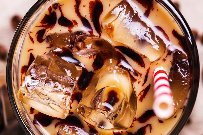 Iced coffee in a glass with a straw