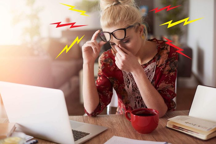 woman at laptop with headache