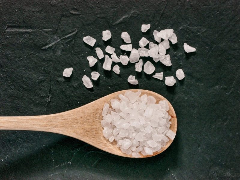 coarse sea salt on dark background close up. Copy space. Flat lay or top view