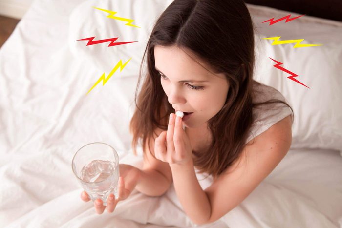 woman taking pain medicine