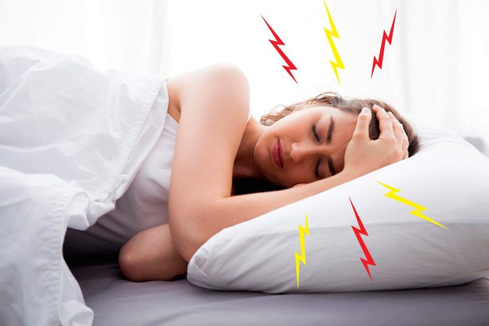 woman with headache in bed