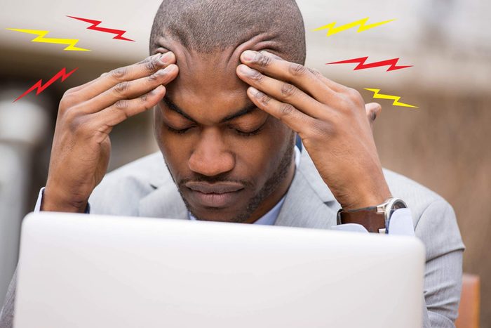 man at laptop with headache