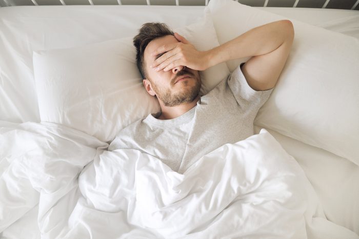 man suffering from insomnia overhead shot