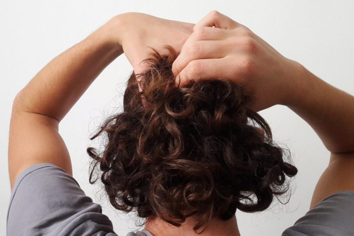 rear view of man touching his hair