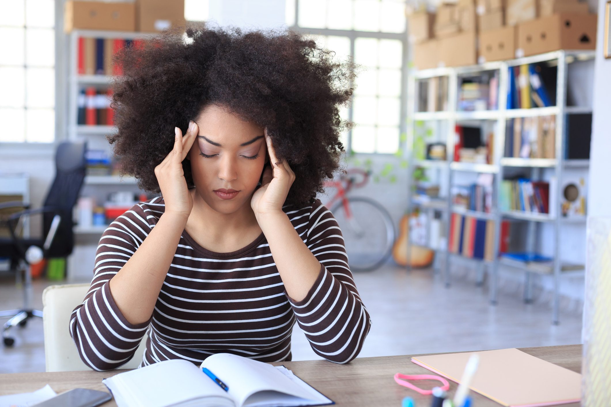 woman with headache pain at work