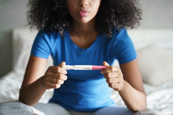 sad woman holding pregnancy test