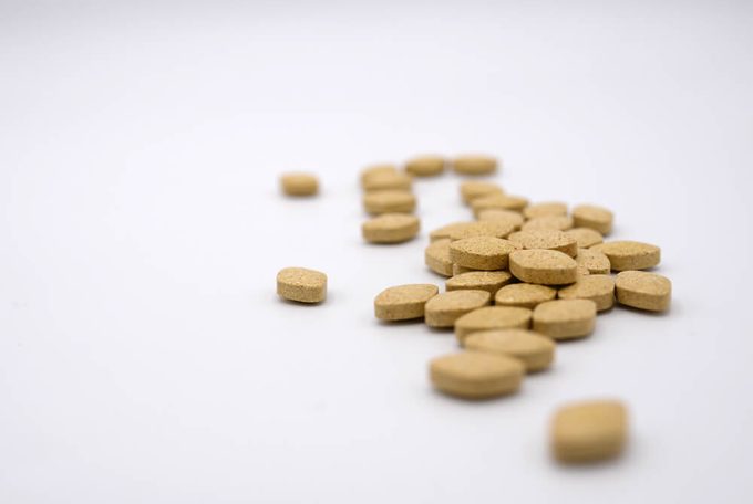 Group of light brown diamond shape pills