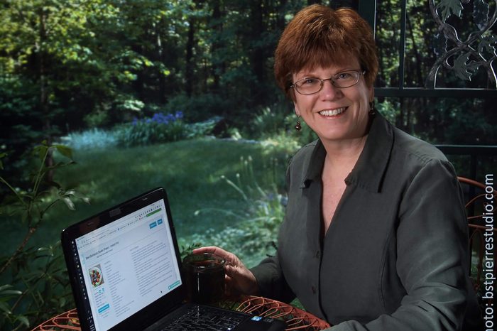 Bonnie St. Pierre sitting at a computer outdoors