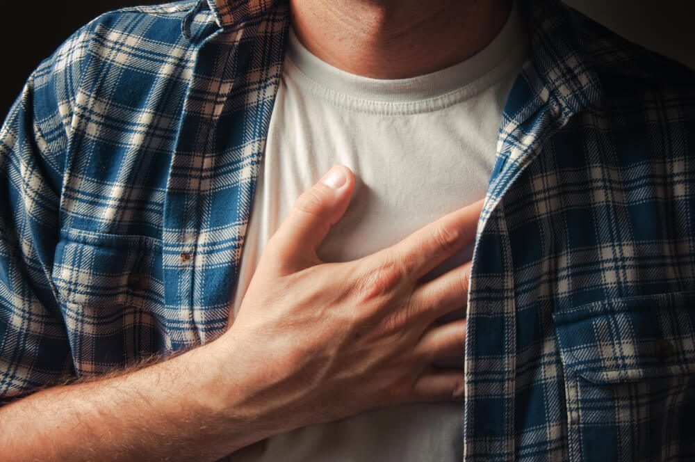 Man suffering from severe chest pain.