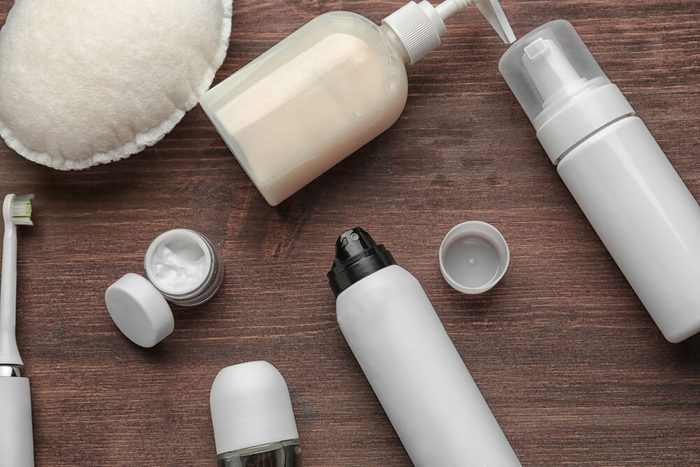 Set for personal care with deodorants on wooden table