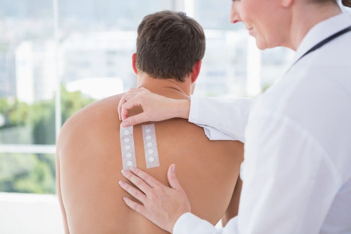 Doctor doing allergy skin test to her patient in medical office