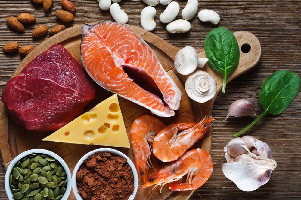 Foods High in Zinc as salmon, seafood-shrimps, beef, yellow cheese, spinach, mushrooms, cocoa, pumpkin seeds, garlic, bean and almonds. Top view