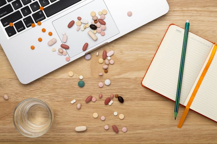 Close-up pills on computer keyboard, concept on line selling pills