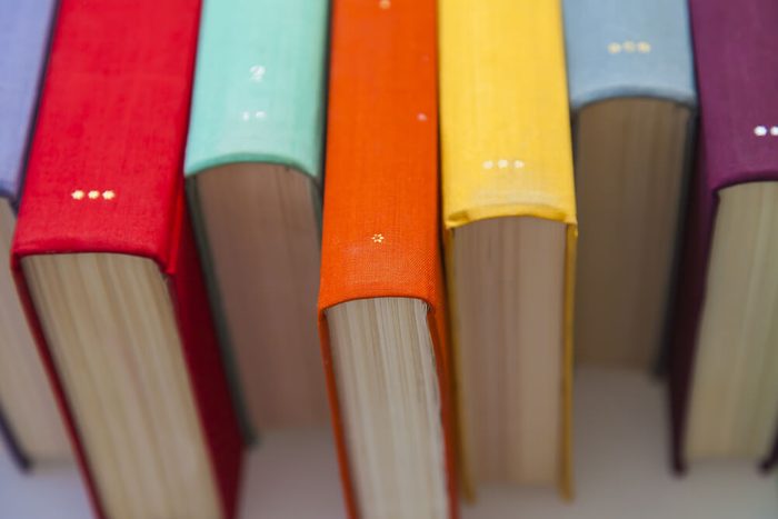 Stack of vintage books in multicolored covers