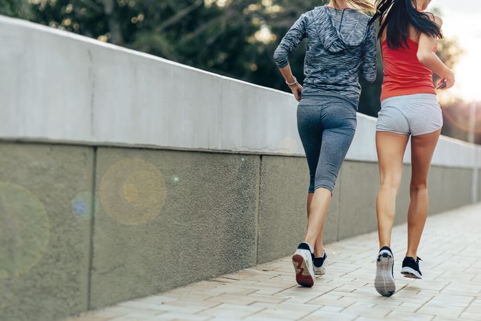 Women jogging in city in dusk