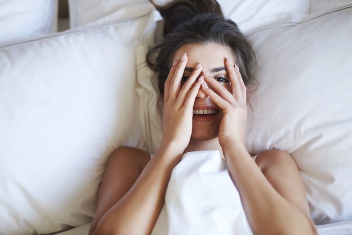 She is little shy woman in bed