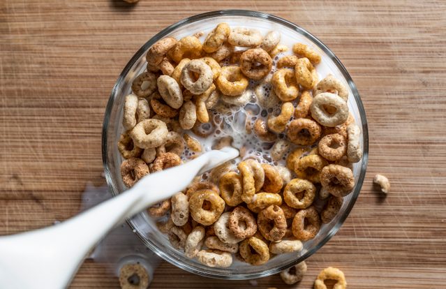 pouring milk over cereal shot from above