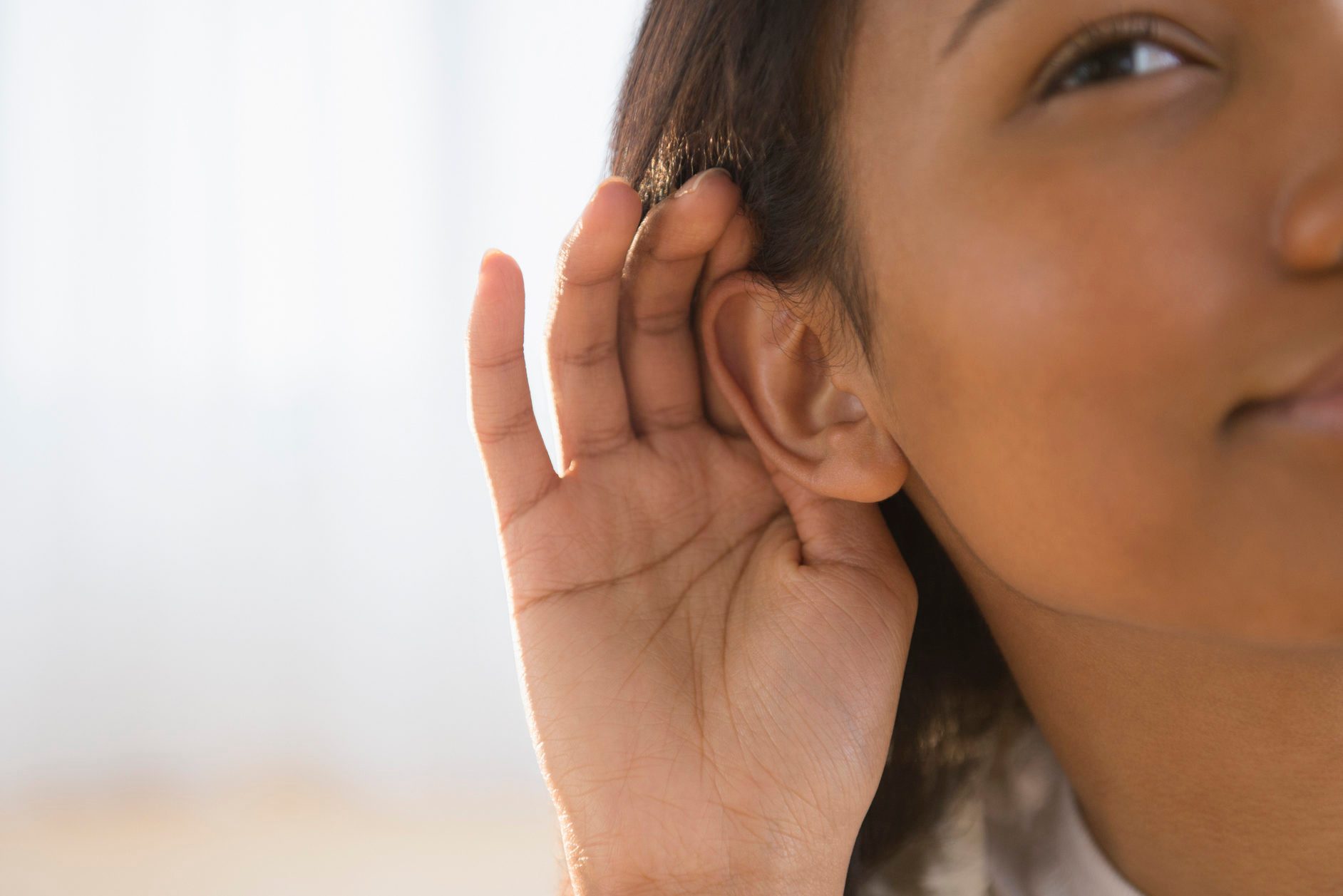 woman cupping her ear