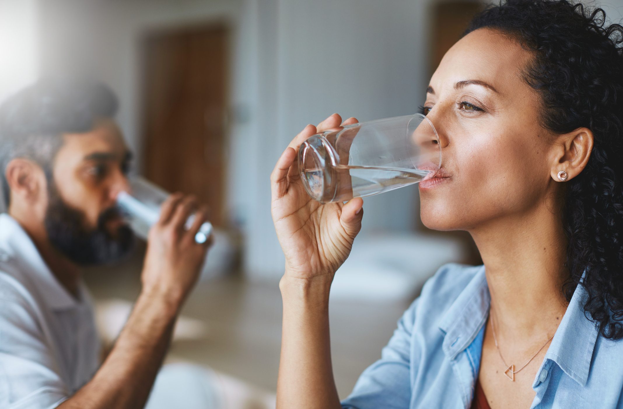 woman and man drinking water