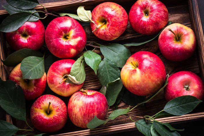 Red apples in wooden tray