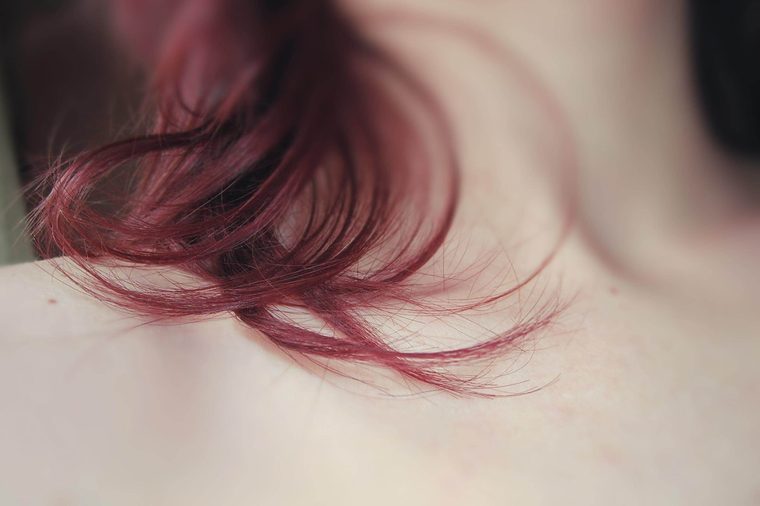 closeup of a woman's hair draped over her neck and collarbone