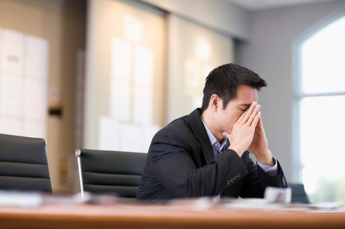 Businessman with Head in Hand