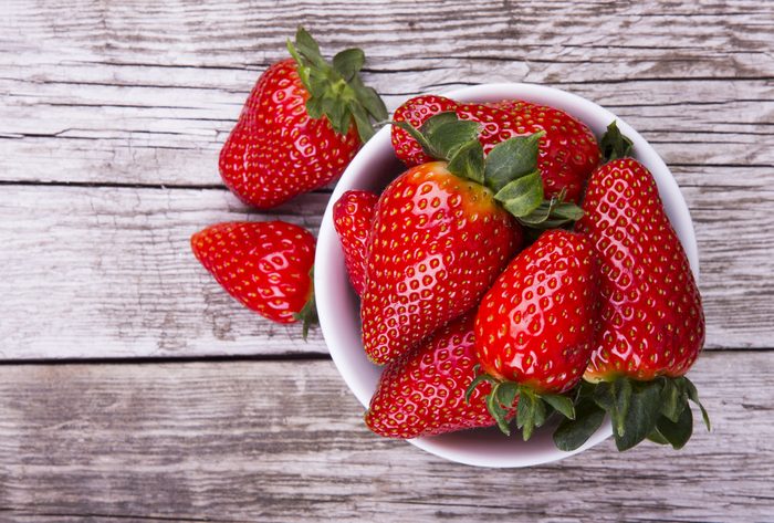 Fresh strawberries on old wooden background