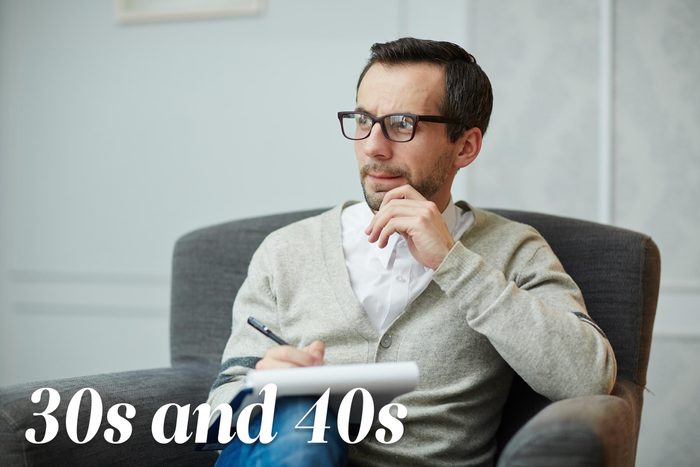 man sitting in chair with notepad