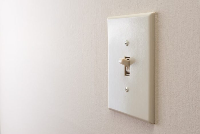 Classic light switch hanging on the wall