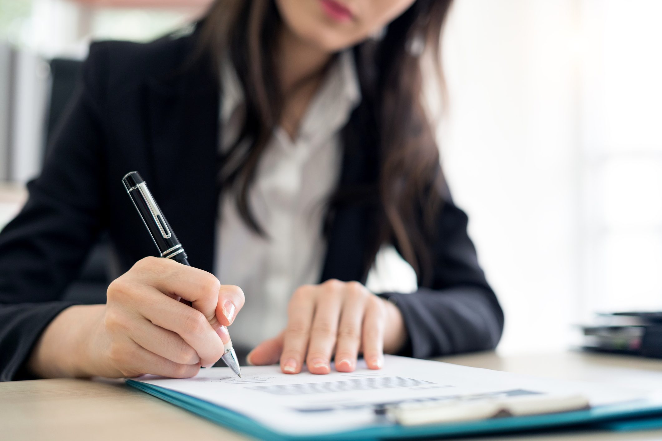 businesswoman signing a contract close up