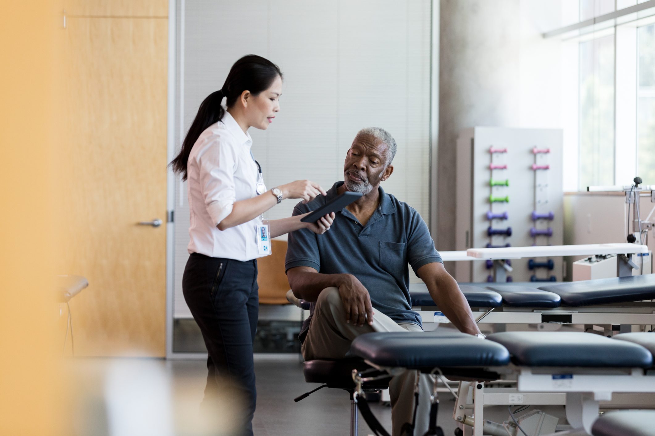 physical therapist talking with patient