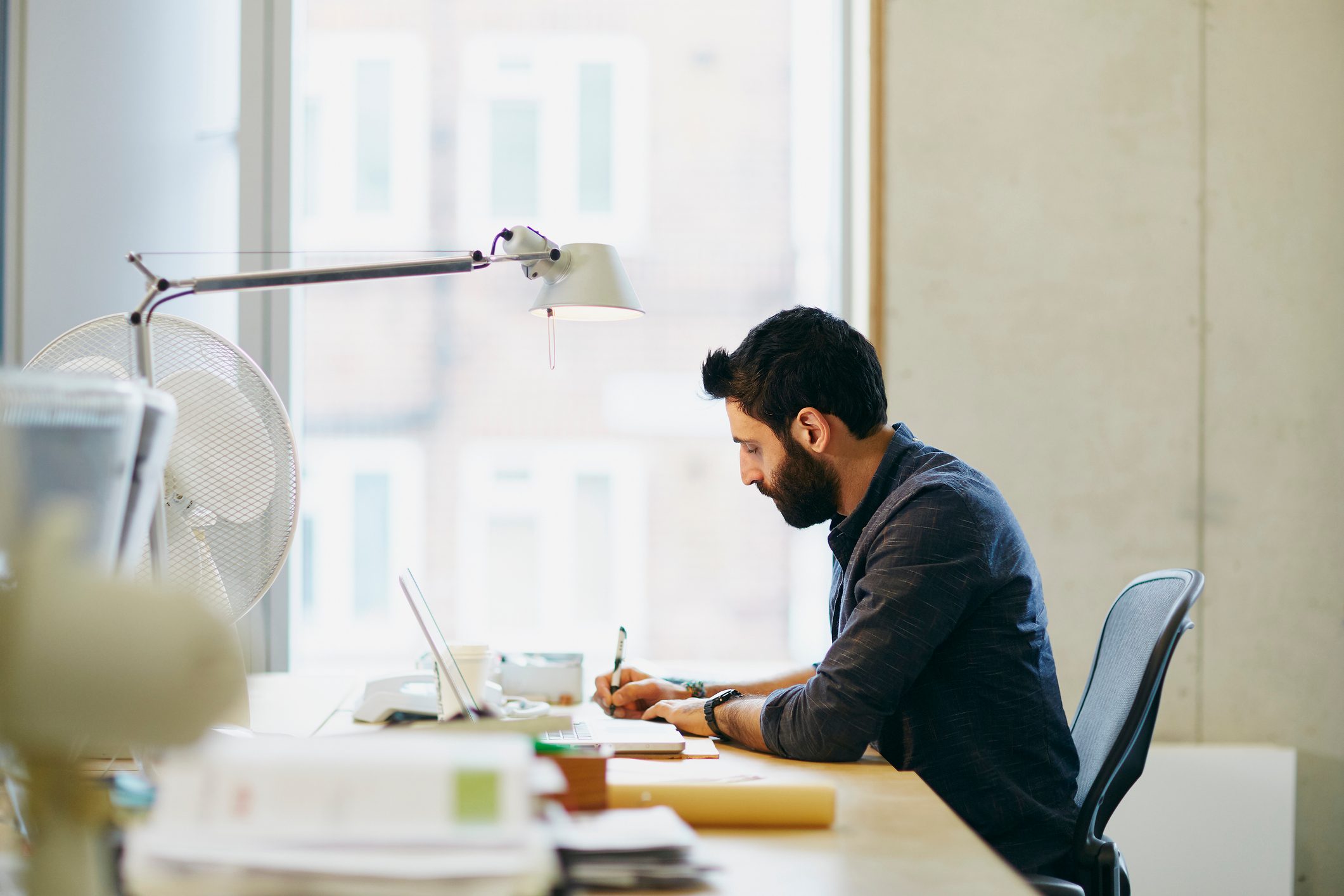 man sitting at desk working