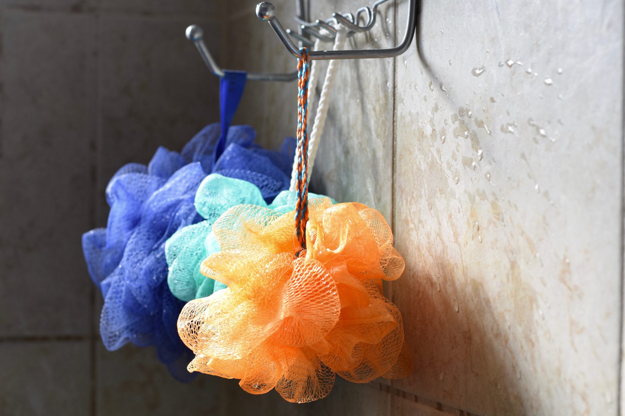 loofahs hanging in the shower