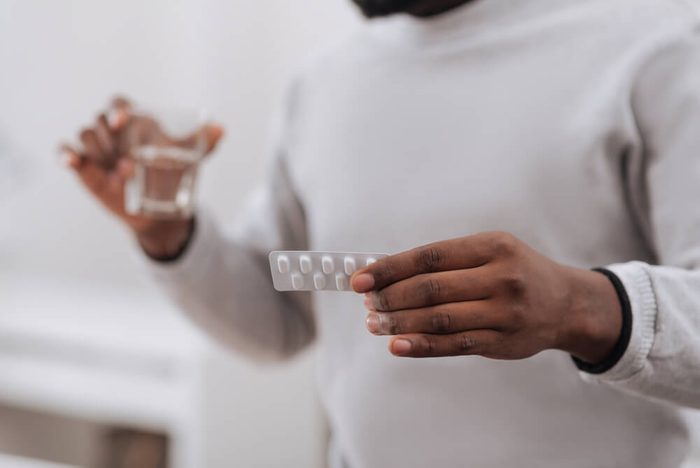 Selective focus of medicine being in hands of a nice adult man