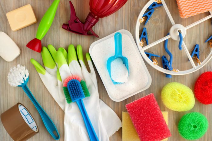 Household utensils for hygiene and cleanliness. Washing powder, clothespins, rubber gloves, brushes are household items. View from above. House utensils of different kinds. Hygiene products for home.