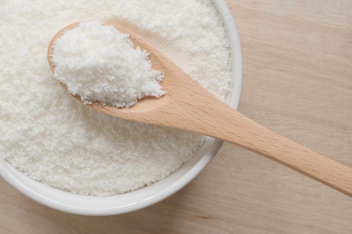  Collagen powder on a wooden spoon