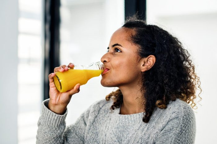 Woman drinking fresh orange juice